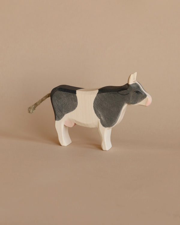 A Ostheimer Cow - Black & White - Standing, standing against a plain beige background.