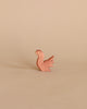 A small, copper-colored Ostheimer Squirrel - Sitting pin stands against a plain light beige background, evoking the imaginative play often inspired by Ostheimer toys.