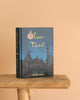 The Oliver Twist | Dickens | Collector's Edition | Hardcover Book stands on a wooden stool against a plain beige background, featuring an illustrated nighttime cityscape and a gold-scripted clock above the title.