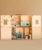 Maileg Suitcasa Furnished Set featuring an open-faced dollhouse suitcase with multiple rooms, Maileg mouse furniture, a fireplace, a Christmas tree, a kitchen unit, and bathroom fixtures.