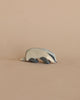 A small metal Ostheimer Badger - Head Down figurine with a handcrafted design and brushed finish on a plain beige background.
