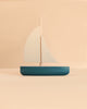 A Sabo Concept Sailboat, a minimalist wooden toy with a dark blue hull and two light-colored sails, perfect for imaginative play.