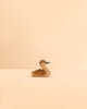 A handcrafted wooden Ostheimer Canada Goose - Small in a resting position, made in Germany.