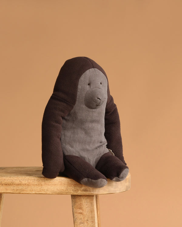The Maileg Gorilla, Medium features soft fabric, dark brown arms, and a light gray face and belly. It’s perfect for your Safari friends collection or as a charming accent on any shelf or stool.