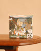 September Harvest Mini - 100 Piece Mini Puzzle box featuring an illustration of people at an outdoor harvest table in front of a farmhouse.