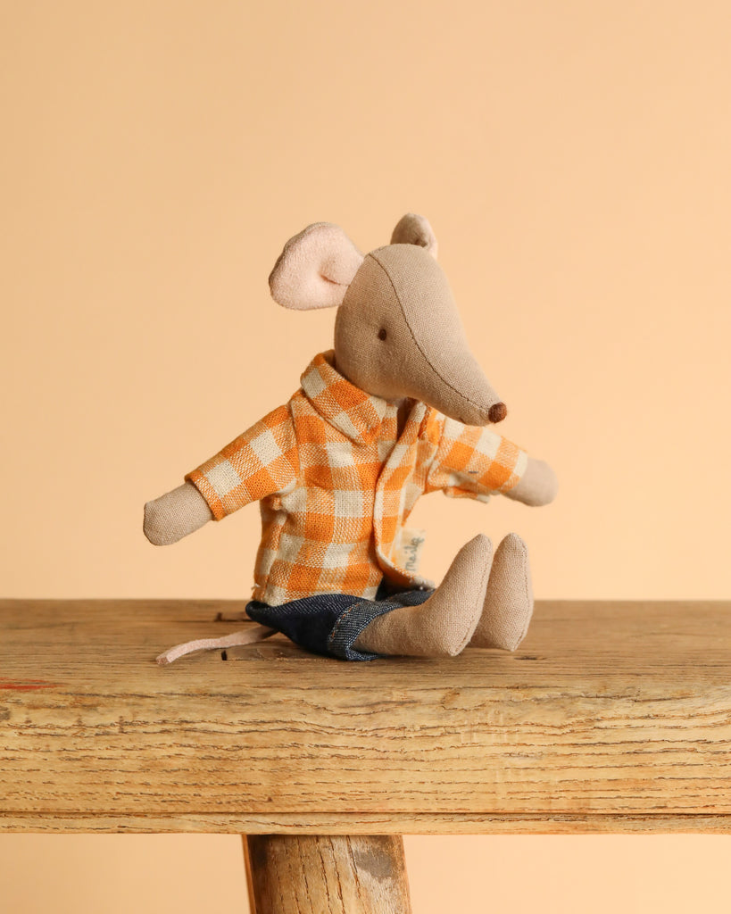 The Maileg Family Room Set includes a stuffed mouse toy in an orange checkered shirt and blue shorts, posed on a wooden surface against a light peach background.