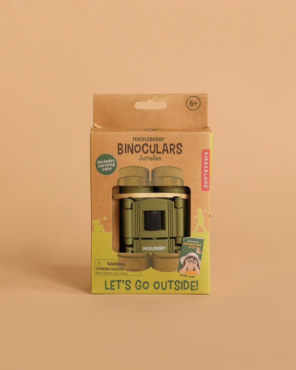 A package of Huckleberry Binoculars for ages 6+, perfect for bird watching and outdoor exploration, in a cardboard box with green binoculars visible and "Let's Go Outside!" label, shown against a plain beige background.