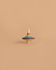 The Mader Rallye Rainbow Spinning Top, Small - Purple, featuring vibrant rainbow stripes and crafted from smooth beech wood, rests on a simple beige background.