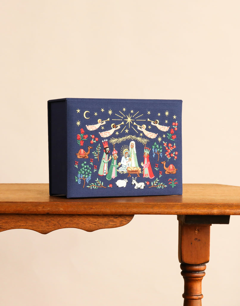 A navy blue rectangular Nativity Large Embroidered Keepsake Box featuring an embroidered nativity scene with angels, the Holy Family, wise men, animals, and stars.