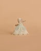 The Maileg Baby Mouse in Gown - Mint stands upright, dressed in a mint celebration gown and lace bonnet, against a plain beige background.