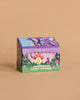 The Magical Minds Garden Kit - Enchanted Fairy Garden comes in a colorful box with whimsical illustrations of a fairy house, mushrooms, flowers, and a purple butterfly on tan—an ideal STEM DIY activity for kids.