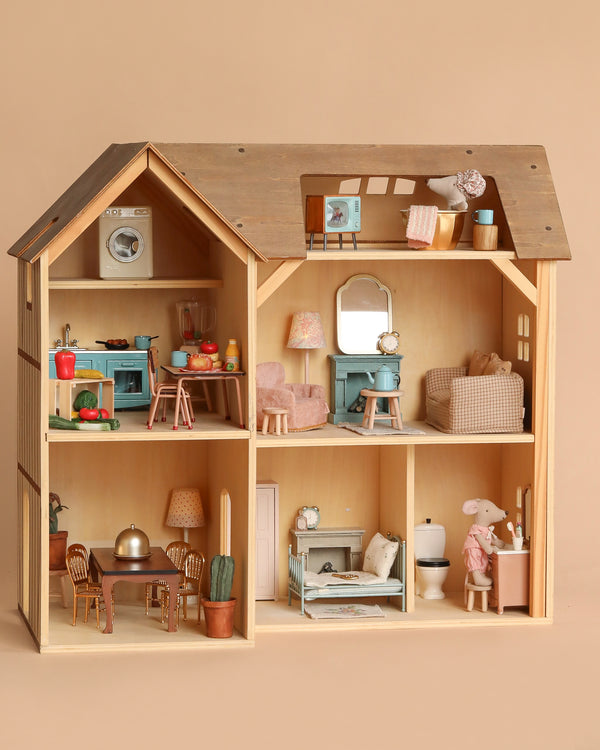 The Maileg Fully Furnished Farmhouse Set + Surprise Gift features six rooms with Maileg Miniature Furniture, delightful accessories, and a toy animal figure. Enjoy detailed spaces—kitchen, bathroom, bedrooms, dining area, and living room. Ships in 1-2 weeks.