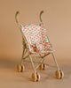 The Konges Sloejd Doll Stroller - Lumina features double wheels and a floral pink and green fabric seat, shown here in a small beige design against a plain beige background.