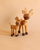 Two Spring Copenhagen Spot The Fawn figurines with a larger FSC Oak deer standing next to a smaller deer calf figure, both with spotted bodies and dark hooves, on a solid beige background.