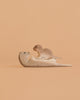 The Bumbu Handmade Wooden Otter Set features an adult otter on its back with a baby otter on its belly, both painted in natural wood tones—an eco-friendly, charming addition to any collection.
