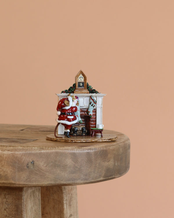 The Wee Forest Folk Tiny Collectible - A Visit From St. Nick shows a hand-sculpted mouse Santa by a white fireplace with wreath and stockings, set on a wooden stool against a plain peach background (Not a Toy).