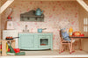 Create a cozy miniature kitchen with the Maileg Fully Furnished Farmhouse Set + Surprise Gift (ships in 1 week), featuring mouse dolls, pastel appliances, veggies, and accessories—perfect for your Maileg Farmhouse Dollhouse.