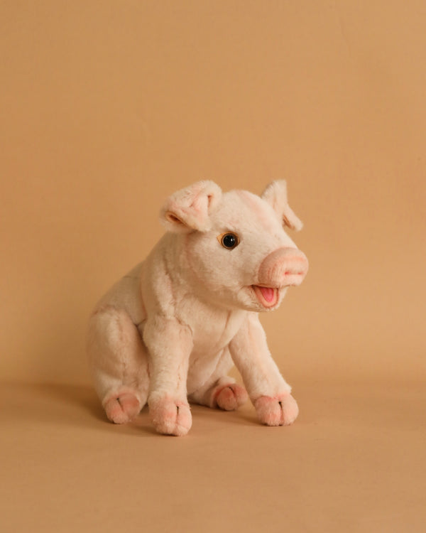 A Pig Stuffed Animal sitting on a beige background, with a soft pink hue, detailed features, and a happy expression.