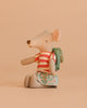 The Maileg Big Sister Tricycle Set features a mouse in a red and white striped shirt, floral skirt, and green backpack, seated on a beige background.