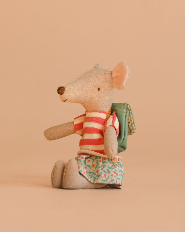 The Maileg Tricycle Mouse, Big Sister - Green wears a red and white striped shirt, green patterned skirt, and green backpack, sitting upright against a plain beige background.