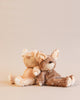 Two stuffed dolls in deer costumes photographed leaning against each other. 
