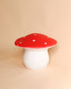 A ceramic stool shaped like a **Medium Red Mushroom Lamp**, with a glossy red cap dotted with white spots and a smooth white stem, perfect as children's room decor, set against a plain beige background.