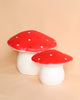 Two Medium Red Mushroom Lamps, set against a soft peach background, perfect as children's room decor.