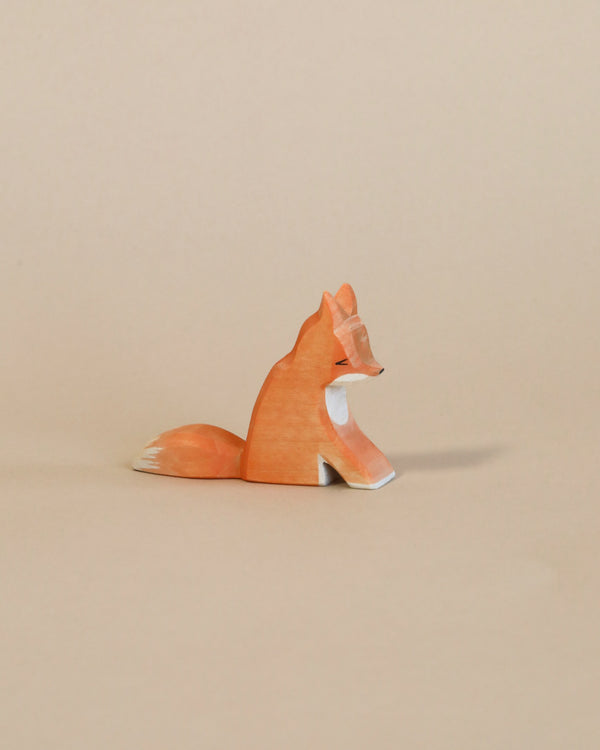 A Ostheimer Fox - Sitting displayed against a plain beige background, featuring an orange and white color scheme with smooth, handcrafted details.