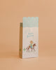 The Maileg Goodie Bags - Happy Birthday - Cowboy (12 Pieces) feature pastel colors, blue stripes, a cowboy on horseback illustration, and "happy Birthday" text—perfect for small gift or party favor bags.