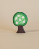 A handcrafted wooden Ostheimer Apple Tree figurine painted green with white flowers on a plain beige background, embodying the principles of imaginative play typical of Ostheimer toys. The tree boasts a distinct round canopy.