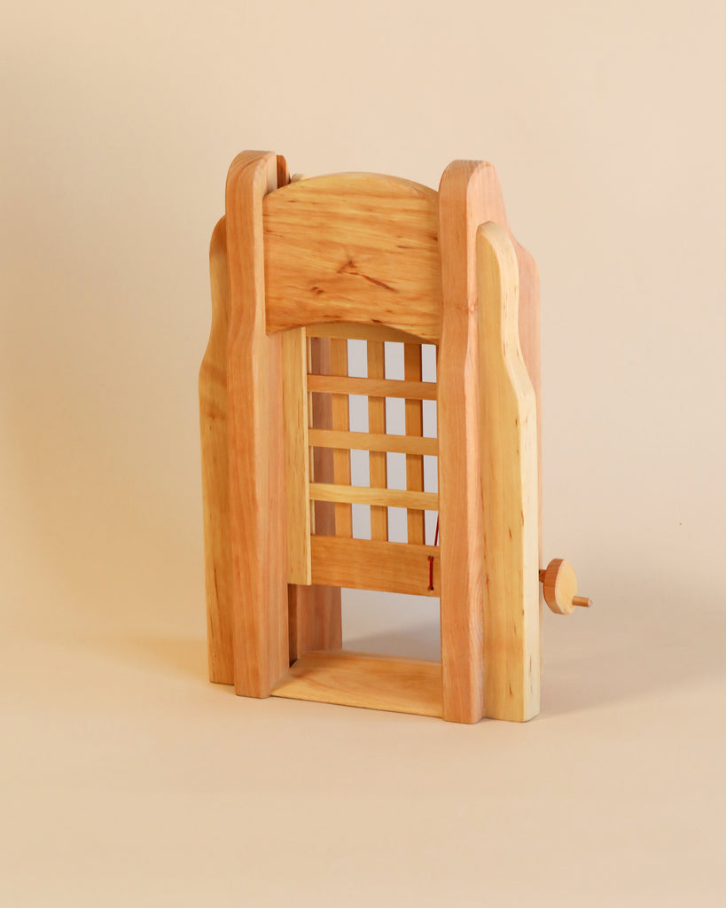 A wooden Ostheimer Portcullis with a lattice backrest, crafted from sustainably sourced materials, exhibiting a modern design and smooth finish, on a beige background.
