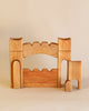 Ostheimer Gateway - Set With 2 Towers arranged to form a structure with an archway and a smaller doorway, set against a plain light background. These handcrafted wooden toys foster creativity and sustainable play.