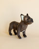A French Bulldog Dog Stuffed Animal, standing profile with a brown coat and attentive expression, crafted from high quality materials set against a plain light beige background.