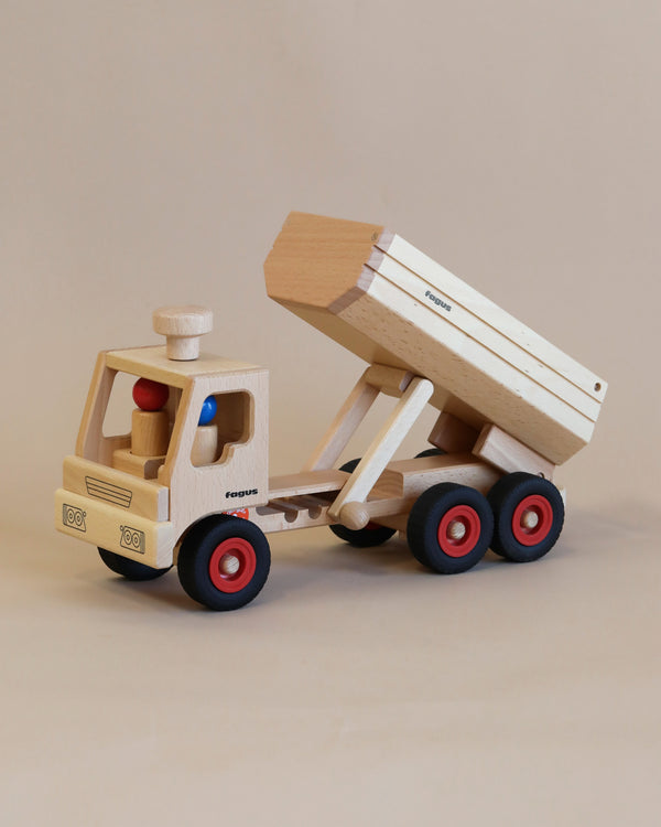 A Fagus Wooden Container Tipper Truck with red wheels and a movable bed, labeled "ecotruck," positioned against a plain beige background.
