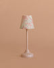 A charming addition to your Maileg mouse closet or dollhouse accessories, the Maileg Bunk Bed Bedroom Set features a small table lamp with a white decorative base and a patterned lampshade in light blue and pink designs, set against a plain beige background—perfect for adding extra charm to any miniature scene.