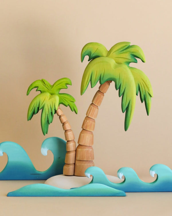 Craft depiction of the Set of Handmade Wooden Palm Trees & Waves, set against ocean waves with a neutral beige background.