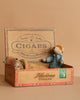 The Maileg Family Christmas Set features two small Mum & Dad mice in an open vintage cigar box with retro labels—one mouse sits up while the other lies under a blanket, set against a plain beige background.