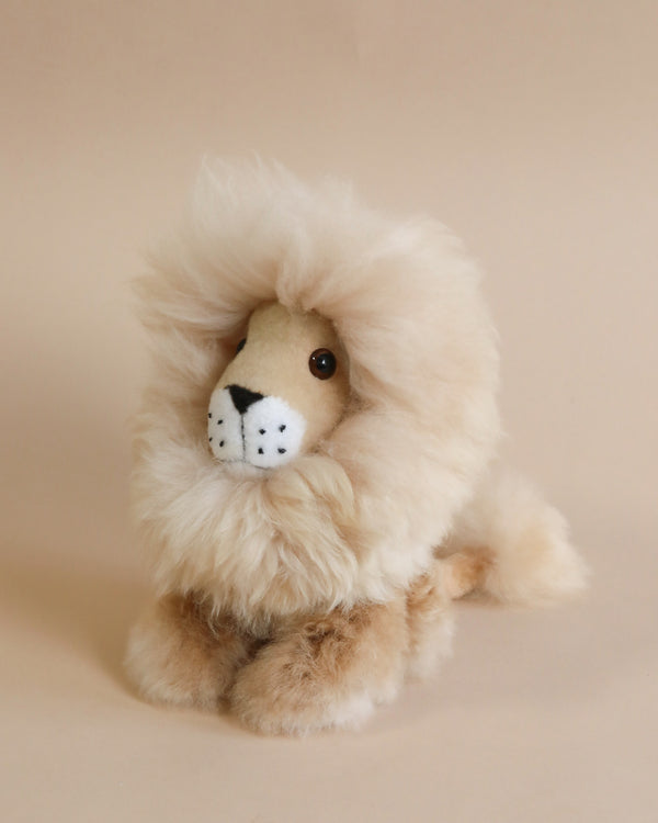A Fluffy Lion Stuffed Animal with a fluffy mane and a soft beige and white body, sitting against a plain light beige background.