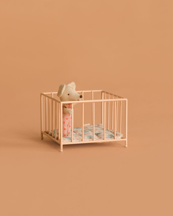 A small toy mouse in pink pajamas stands inside the Maileg Playpen, My - Rose, with a blue-patterned blanket, set against a plain beige background.