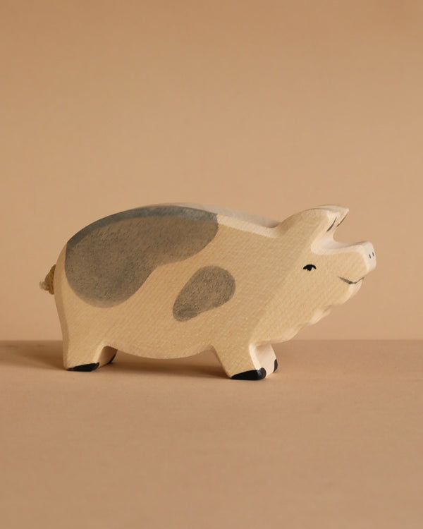 The Holtztiger Boar is a high-quality, handcrafted wooden figurine featuring light beige and gray spots, a smiling face, and minimal details. Perfect for any collection, it ships in one week.