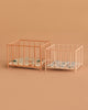 Two Maileg Playpen, My - Rose with patterned mattresses are placed side by side on a beige background. The playpens have a similar design but vary in size.