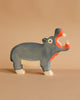 A blue-painted wooden Holztiger hippopotamus toy from the Holztiger Handmade Wooden Safari Animals Set with an open mouth.