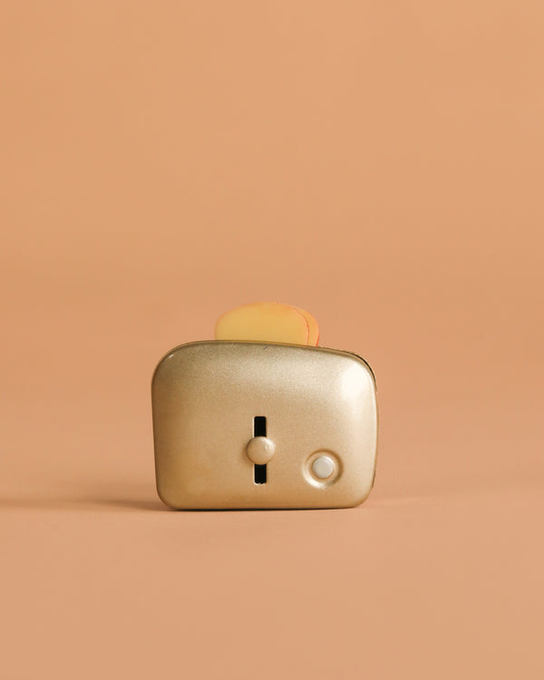 The Maileg Toaster with Bread, Large Size - Silver features a metallic finish and includes toy bread—perfect for any children's kitchen set.