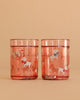 Two Konges Sloejd Glitter Cups - Woof Letter Rose (2 Pack) in pink, featuring playful white dog and bow illustrations—an adorable and fun dinnerware choice for kids.