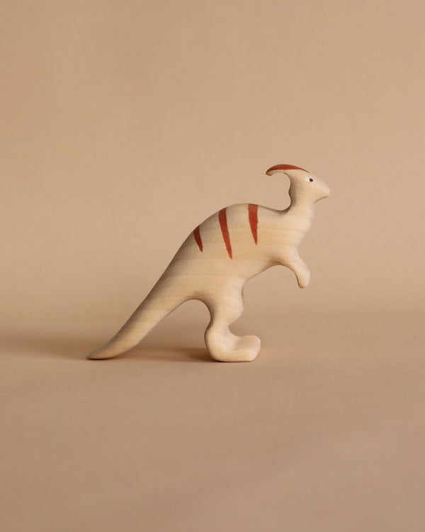 A Handmade Wooden Parasaurolophus Dinosaur, painted with child-safe paint featuring minimalist red stripes on a beige background.