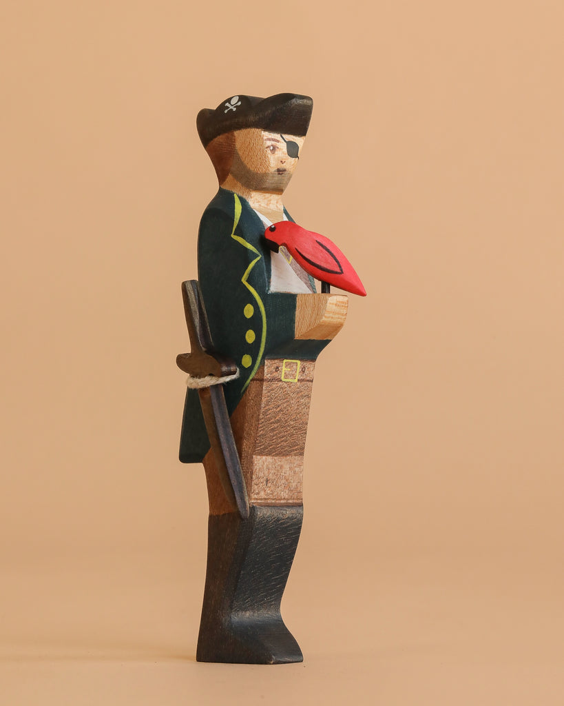 The Handmade Holzwald Pirate and Parrot features a pirate in a black hat and coat with a red parrot on his shoulder, holding a sword against a beige background—a perfect sustainable toy for any collection.