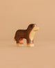 The Handmade Holzwald Bernese Mountain Dog is a small wooden figurine featuring brown, black, and beige painted details—ideal for imaginative play and a delightful addition to any sustainable toy collection.
