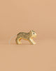 The Handmade Holzwald Small Snow Leopard is a wooden toy with painted details and a string on its back, ideal for imaginative play and photographed on a plain beige background.