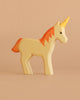 The Handmade Holzwald Unicorn features an orange mane and tail, yellow horn, and neutral expression, made from sustainable wood—a perfect eco-friendly toy for unicorn lovers.