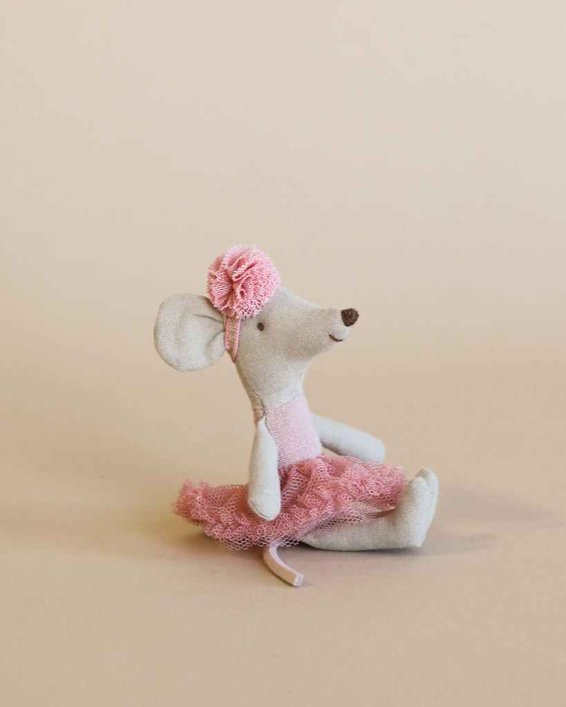 A Maileg Little House Living Room Travel Set features a small gray ballerina mouse in a pink tutu and matching headband, sitting upright against a plain beige background.